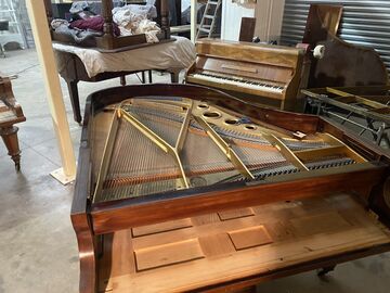 The action is removed from the Bluthner grand to be overhauled on the bench